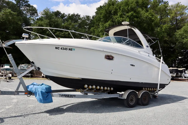 Slide: The Image of 2010 Sea Ray Sundancer 260 boat on trailer, parked outdoors. - 5