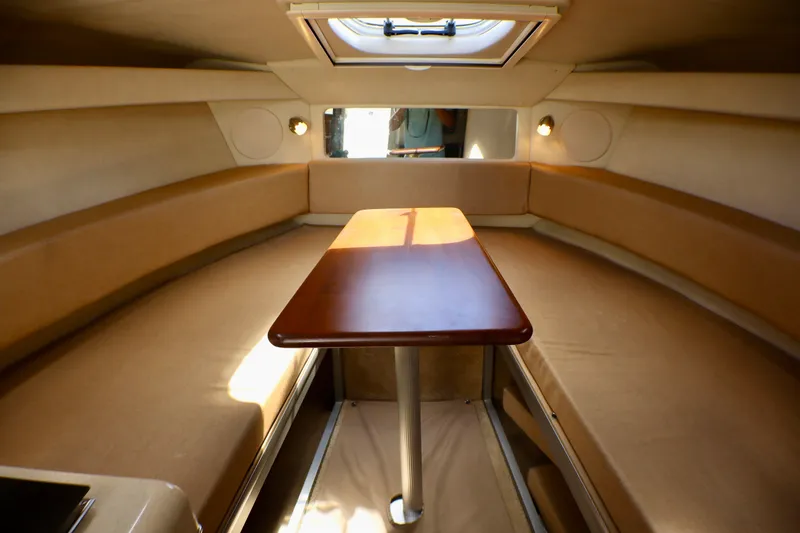 Slide: The Image of Interior of 2010 Sea Ray Sundancer 260, featuring cozy seating and a wooden table. - 41