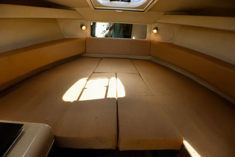 Slide: The Image of Interior cabin of 2010 Sea Ray Sundancer 260 with beige upholstery and overhead lighting. - 42