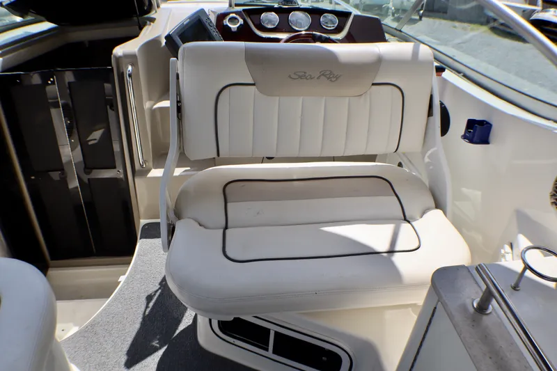 Slide: The Image of Interior of 2010 Sea Ray Sundancer 260 boat with white seating and dashboard. - 27