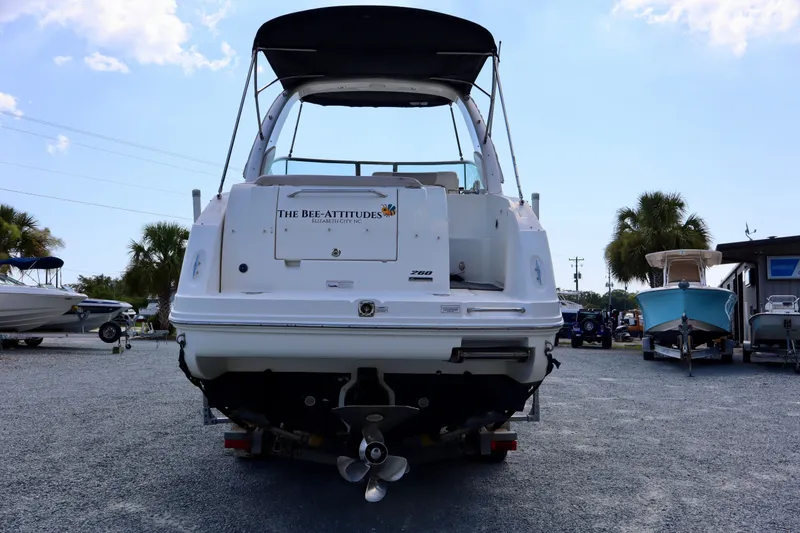 Slide: The Image of 2010 Sea Ray Sundancer 260 boat on trailer, rear view, parked outdoors. - 2