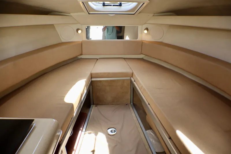 Slide: The Image of Interior cabin of 2010 Sea Ray Sundancer 260 with beige seating and overhead skylight. - 39