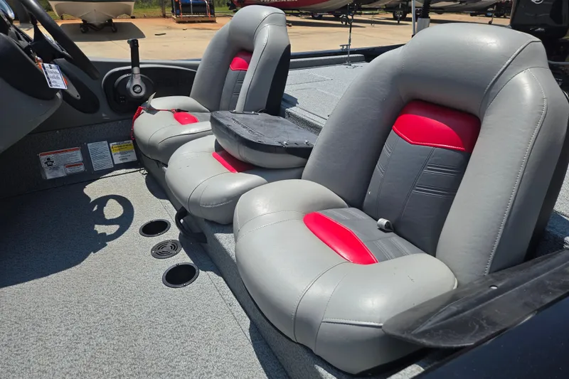 Slide: The Image of 2017 Tracker Pro Team 175 TXW boat interior with gray and red seating. - 15