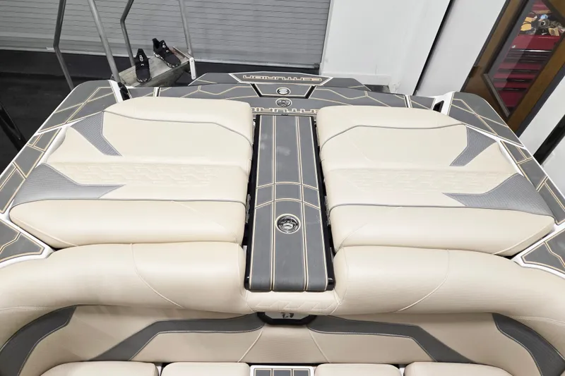 Slide: The Image of 2026 Centurion Ri245 boat interior with beige and gray cushioned seating. - 6