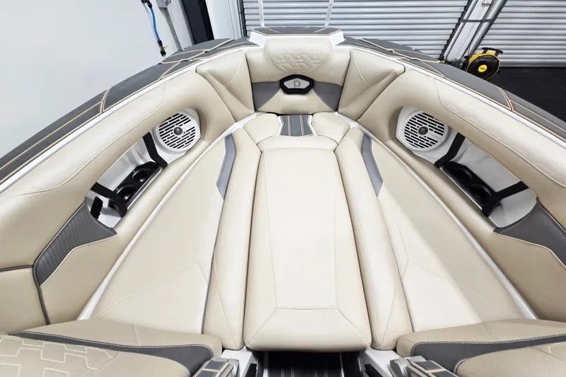 Slide: The Image of Luxurious interior of 2026 Centurion Ri245 boat with beige seating and built-in speakers. - 10