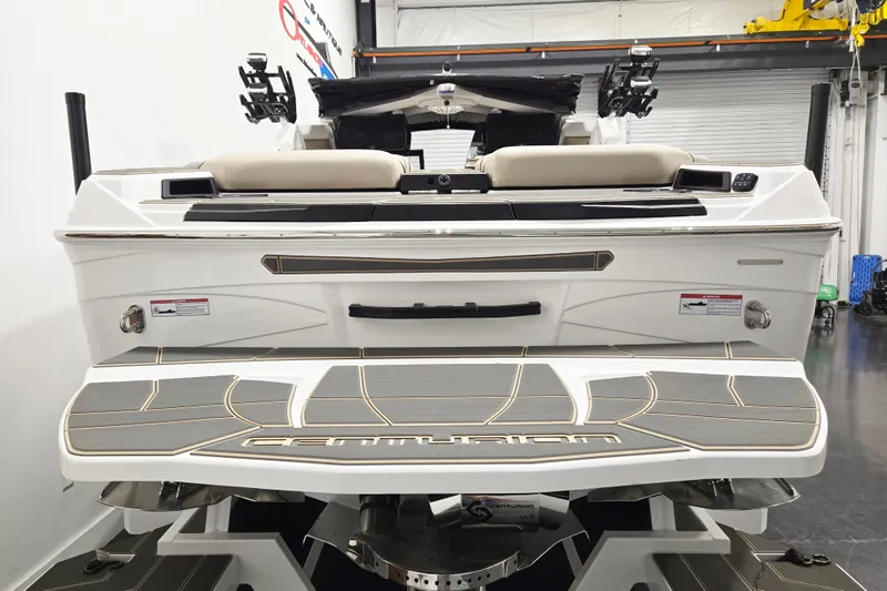 Slide: The Image of 2026 Centurion Ri245 boat rear view in showroom, featuring sleek design and modern features. - 5