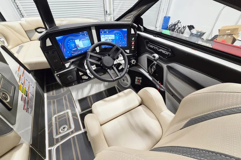 Slide: The Image of 2026 Centurion Ri245 boat interior with advanced dual-screen dashboard and luxurious seating. - 7