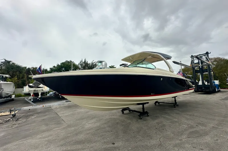 Slide: The Image of 2026 Chris-Craft Launch 35 GT boat on display under cloudy skies. - 2