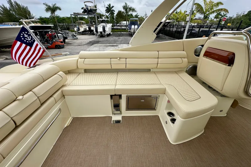 Slide: The Image of Luxurious interior of 2026 Chris-Craft Launch 35 GT boat with beige seating and American flag. - 15