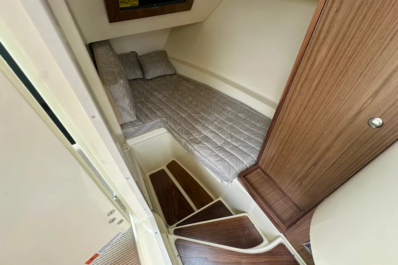 Slide: The Image of 2026 Chris-Craft Launch 35 GT cabin interior with cozy bed and wooden accents. - 22