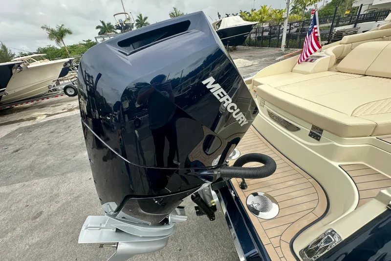 Slide: The Image of 2026 Chris-Craft Launch 35 GT with Mercury outboard engine, docked with American flag. - 25