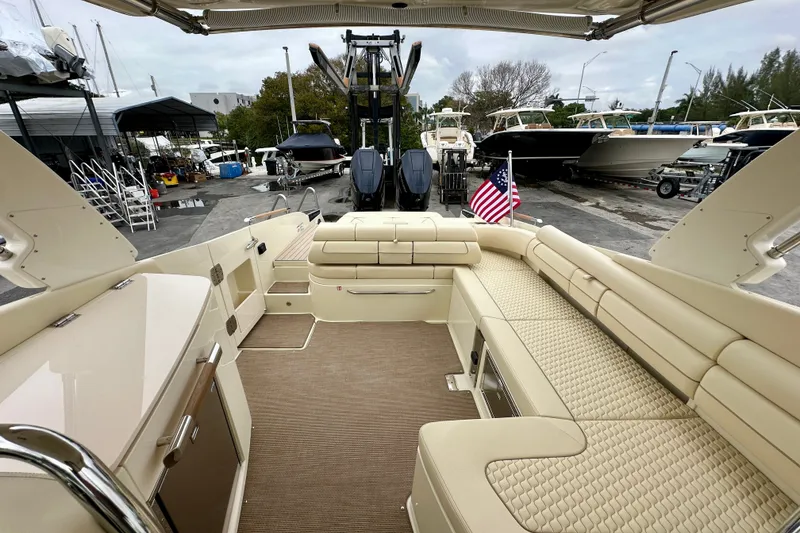 Slide: The Image of Luxurious 2026 Chris-Craft Launch 35 GT boat interior with beige seating and American flag. - 11