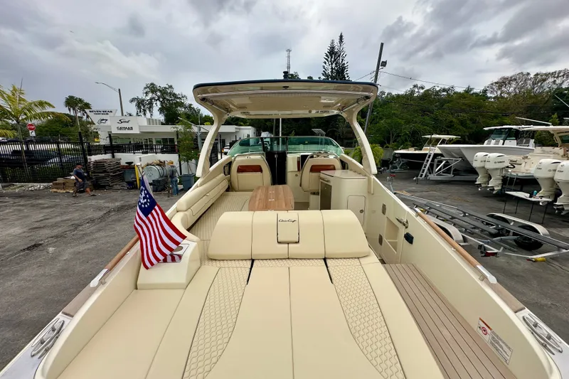 Slide: The Image of 2026 Chris-Craft Launch 35 GT boat with luxurious seating and American flag, docked outdoors. - 21