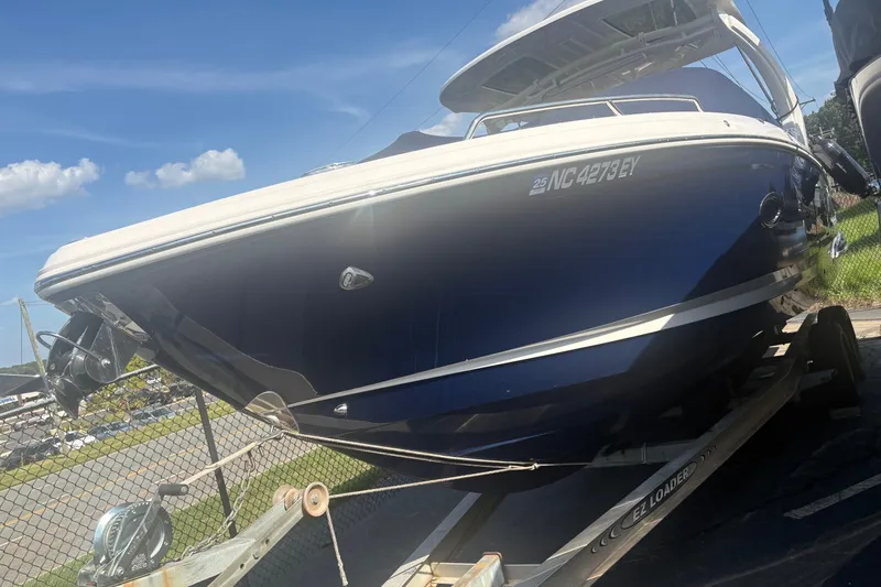 Slide: The Image of 2022 Chaparral 307 SSX boat on trailer under clear blue sky. - 3