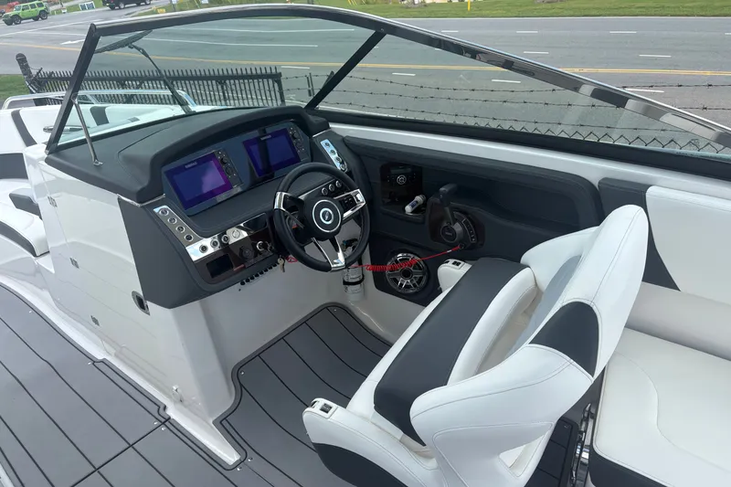 Slide: The Image of 2022 Chaparral 307 SSX boat cockpit with modern steering and dual displays. - 12