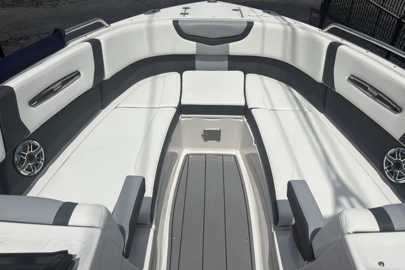Slide: The Image of 2022 Chaparral 307 SSX boat interior with white and gray seating, modern design. - 6