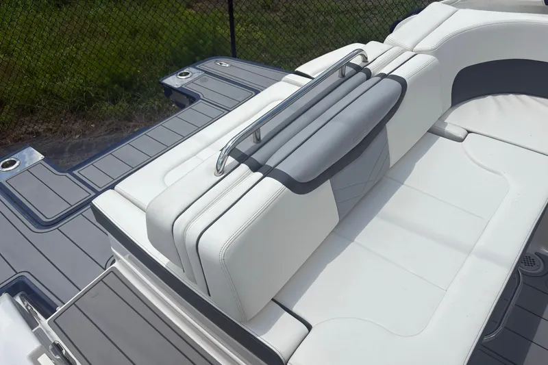 Slide: The Image of 2022 Chaparral 307 SSX boat with sleek white seating and gray deck. - 15