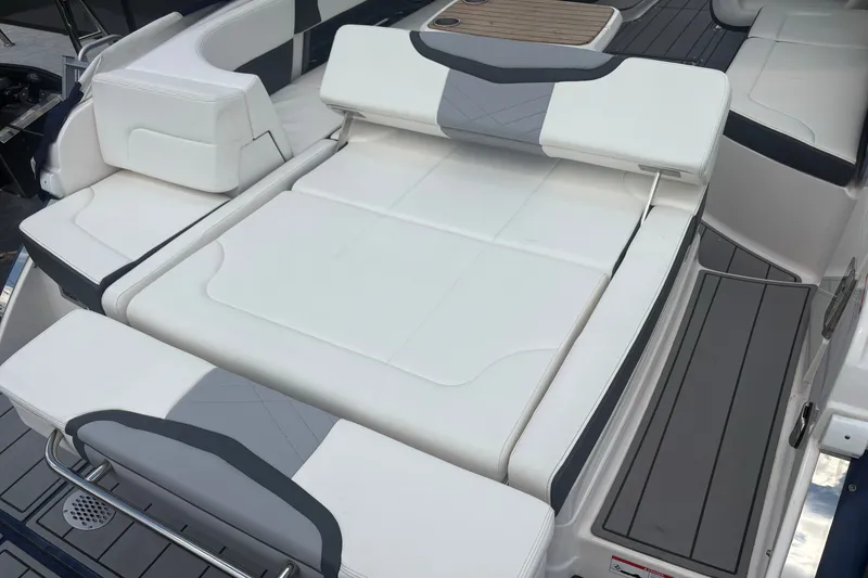 Slide: The Image of 2022 Chaparral 307 SSX boat with luxurious white seating and sleek deck design. - 14