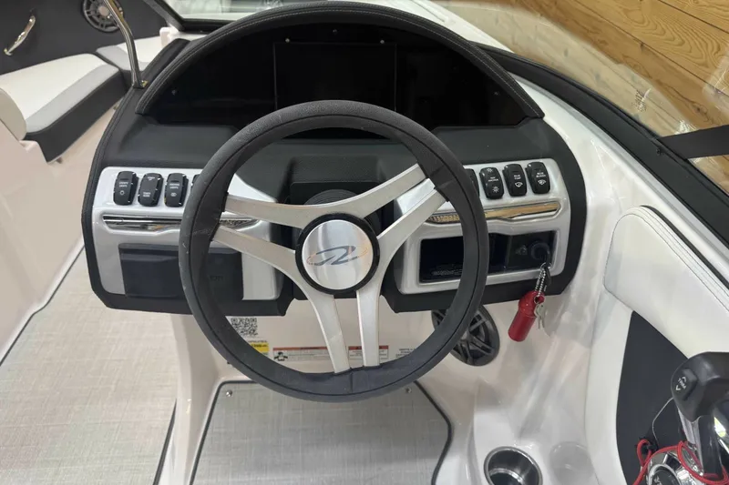 Slide: The Image of Steering wheel and dashboard of 2025 Regal 2000 ES boat, featuring modern controls. - 9