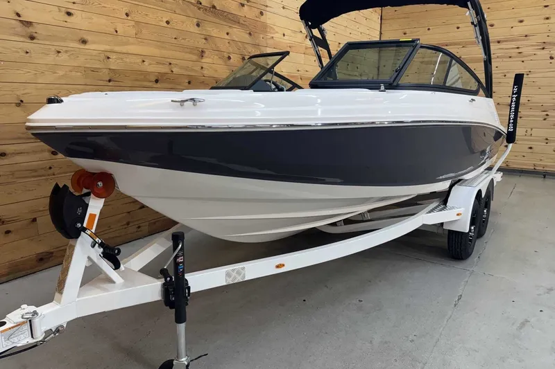 Slide: The Image of 2025 Regal 2000 ES boat on trailer in wooden garage setting. - 4