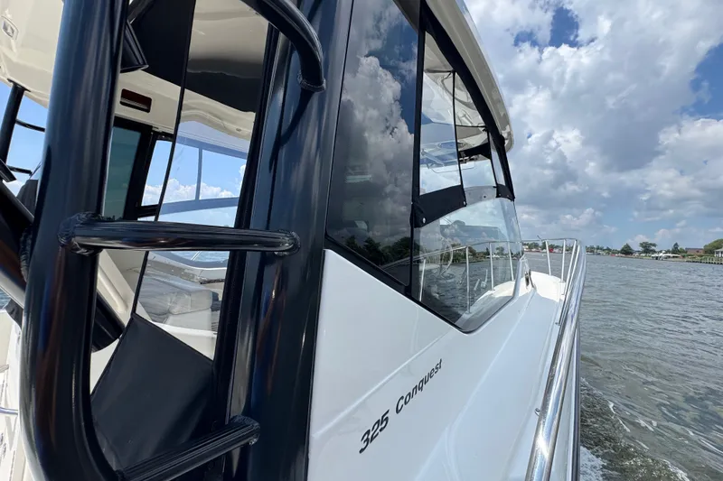 Slide: The Image of 2023 Boston Whaler 325 Conquest boat cruising on a sunny day with clear skies. - 6