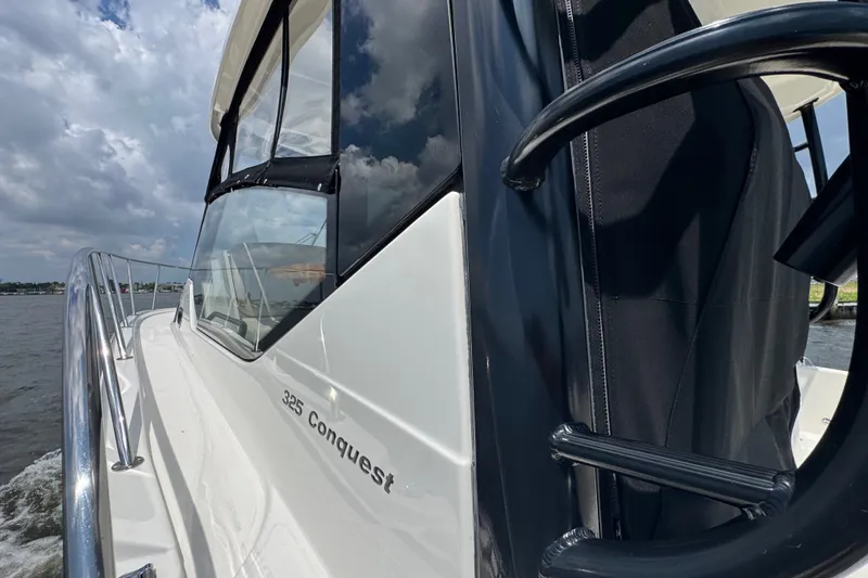 Slide: The Image of 2023 Boston Whaler 325 Conquest boat on water, showcasing sleek design and modern features. - 7