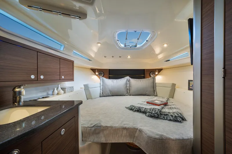 Slide: The Image of Manufacturer Provided Image: Luxurious cabin interior of 2023 Boston Whaler 325 Conquest boat with cozy bed and modern amenities. - 19