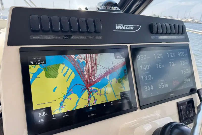 Slide: The Image of Dashboard of 2023 Boston Whaler 325 Conquest with Garmin navigation displays. - 25