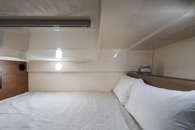 Slide: The Image of Manufacturer Provided Image: 2023 Boston Whaler 325 Conquest cabin interior with bed and pillows. - 22