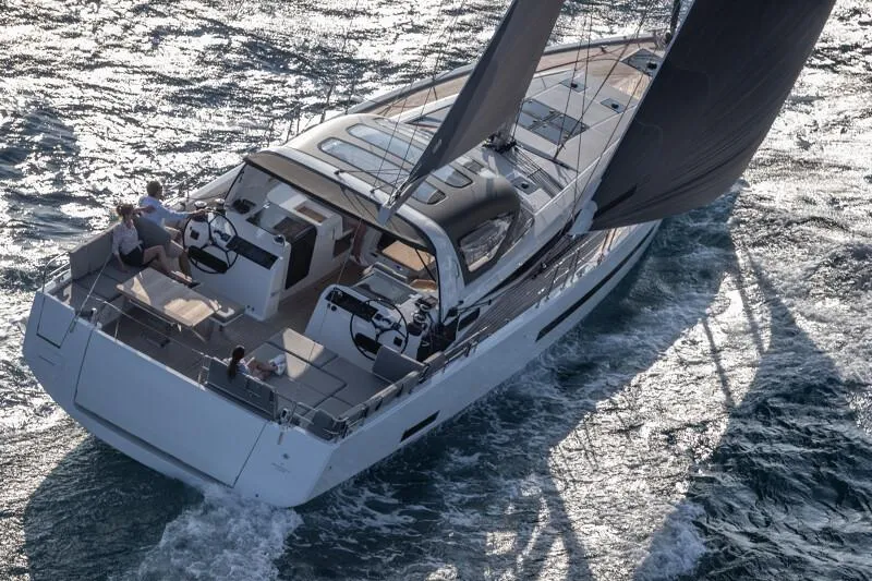 Slide: The Image of Manufacturer Provided Image: 2026 Jeanneau 55 yacht sailing on open water, showcasing sleek design and dual steering wheels. - 2