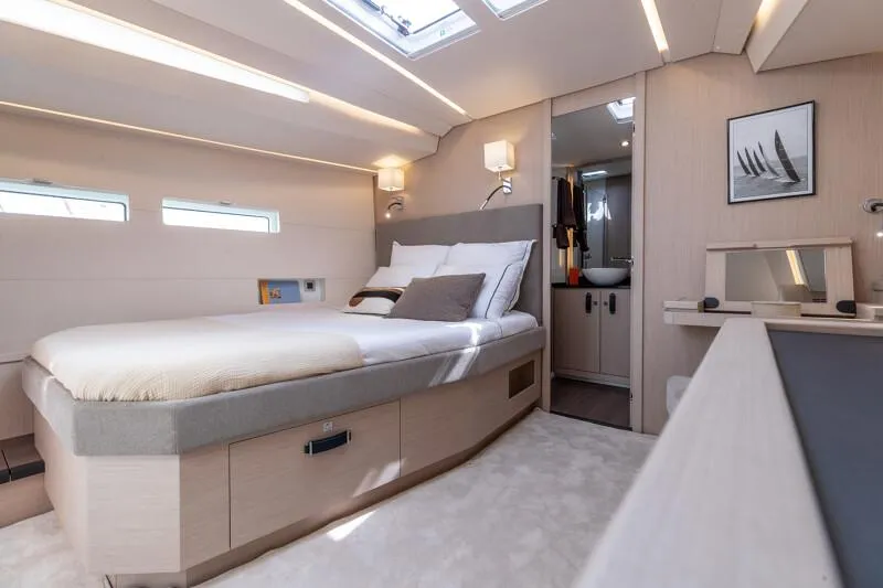 Slide: The Image of Manufacturer Provided Image: Luxurious interior of 2026 Jeanneau 55 yacht with modern bedroom and ensuite bathroom. - 9
