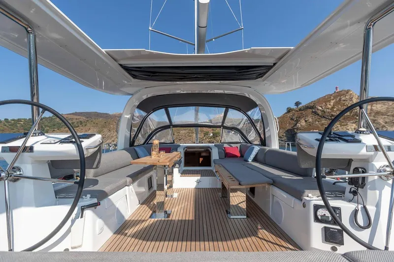 Slide: The Image of Manufacturer Provided Image: Luxurious Jeanneau 60 yacht cockpit, 2025 model, featuring spacious seating and dual steering wheels. - 6