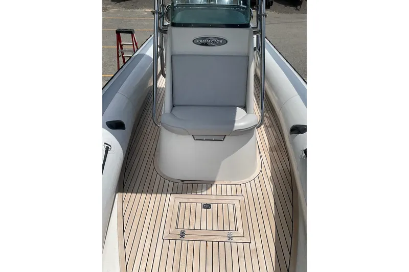 Slide: The Image of 2015 Protector 30 Center Console boat with sleek deck and seating. - 26