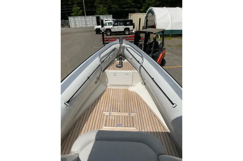 Slide: The Image of 2015 Protector 30 Center Console boat with sleek deck design in a parking area. - 24