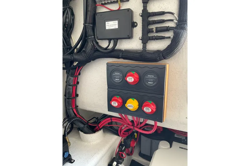 Slide: The Image of Electrical panel with switches and wiring inside a 2015 Protector 30 Center Console boat. - 23