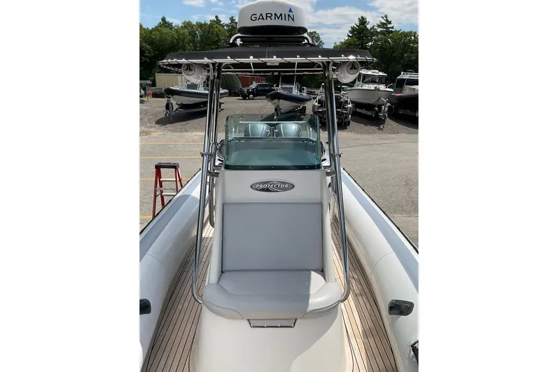 Slide: The Image of 2015 Protector 30 Center Console boat with Garmin equipment, docked outdoors. - 25