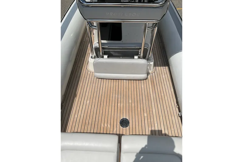 Slide: The Image of 2015 Protector 30 Center Console boat interior with teak flooring and seating. - 8