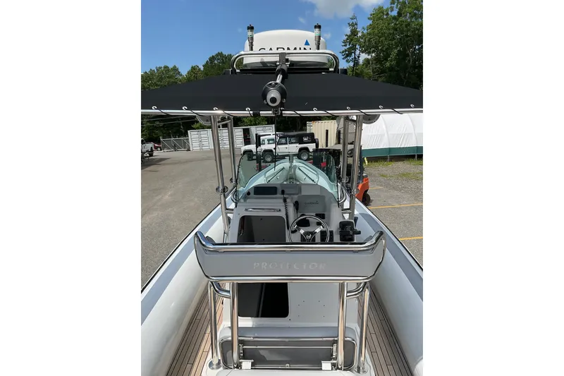 Slide: The Image of 2015 Protector 30 Center Console boat with sleek design and modern navigation equipment. - 14