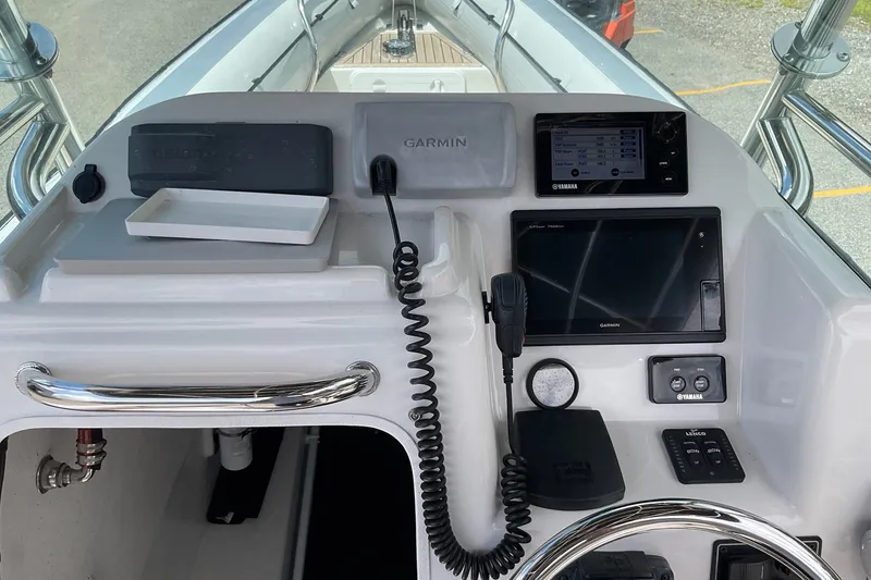 Slide: The Image of Control panel of a 2015 Protector 30 Center Console boat with Garmin electronics. - 21
