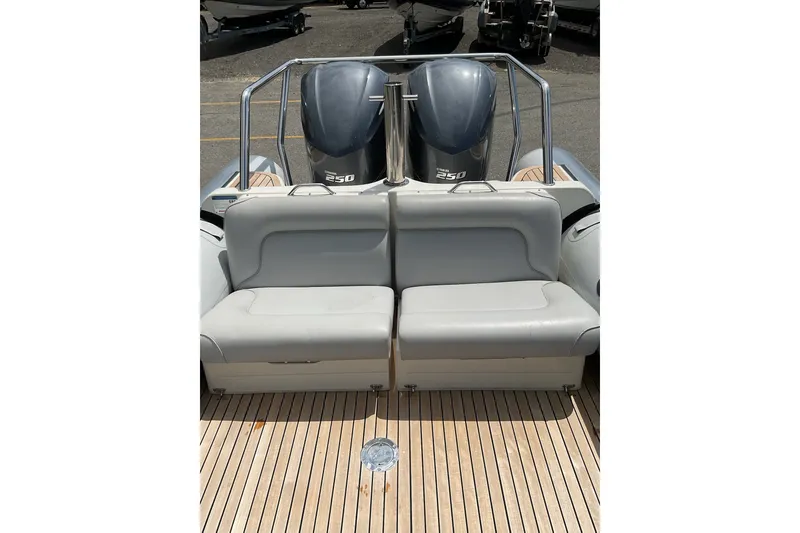 Slide: The Image of 2015 Protector 30 Center Console boat with twin 250 engines and cushioned seating. - 17