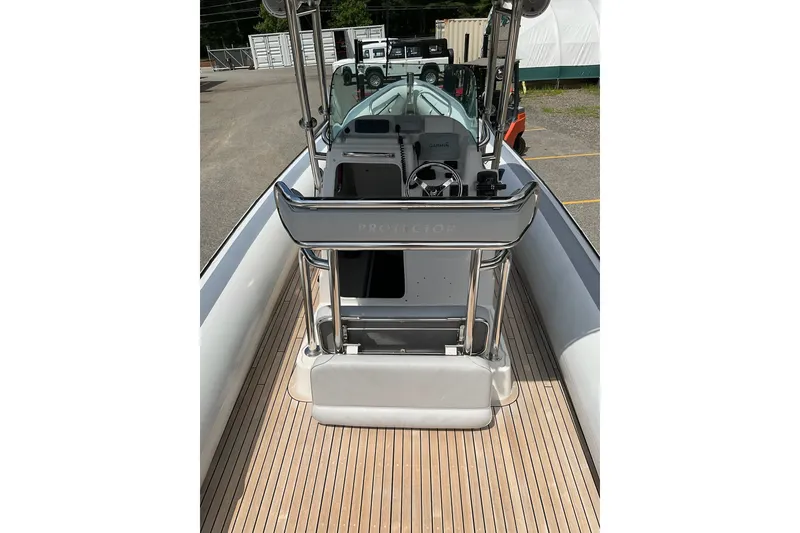 Slide: The Image of 2015 Protector 30 Center Console boat with sleek deck and modern controls. - 13