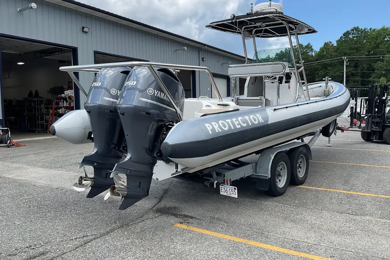 Slide: The Image of 2015 Protector 30 Center Console boat with twin Yamaha 250 engines on a trailer. - 7