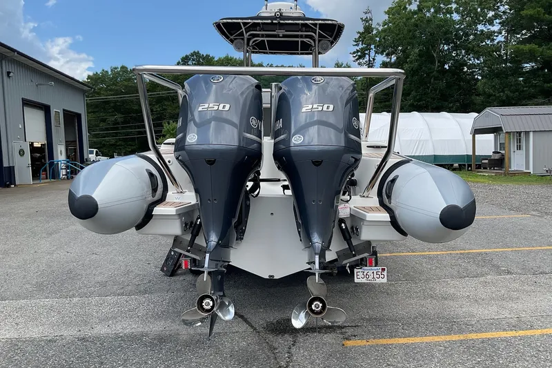 Slide: The Image of 2015 Protector 30 Center Console boat with dual Yamaha 250 engines, parked outdoors. - 2