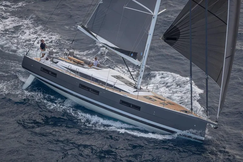 Slide: The Image of Manufacturer Provided Image: 2025 Jeanneau 60 sailing yacht navigating ocean waters with sleek design and modern sails. - 1