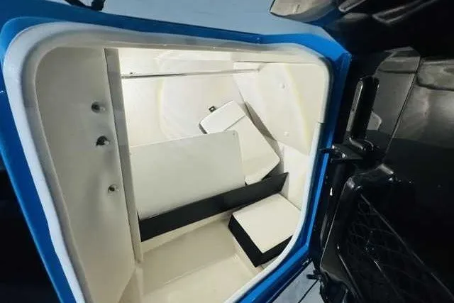 Slide: The Image of Interior storage compartment of 2022 Yamaha Boats 255XD, featuring spacious design and white finish. - 8