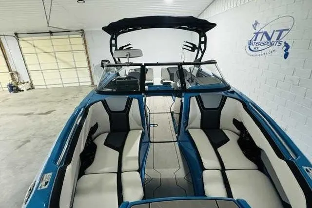 Slide: The Image of 2022 Yamaha Boats 255XD interior with sleek seating in a spacious garage setting. - 5