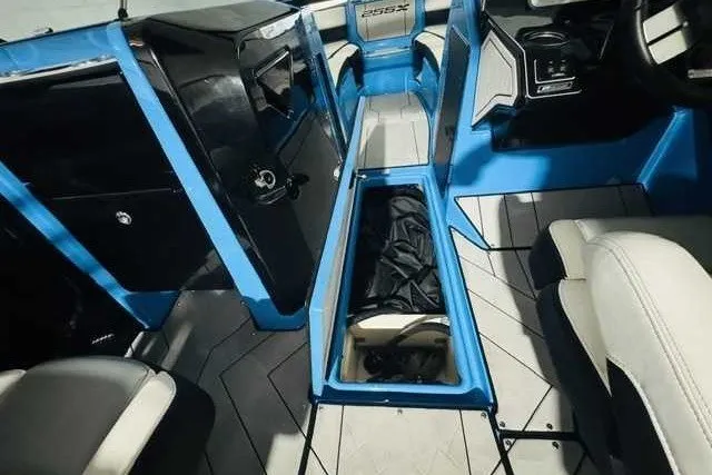 Slide: The Image of 2022 Yamaha Boats 255XD interior with blue accents and storage compartment open. - 7