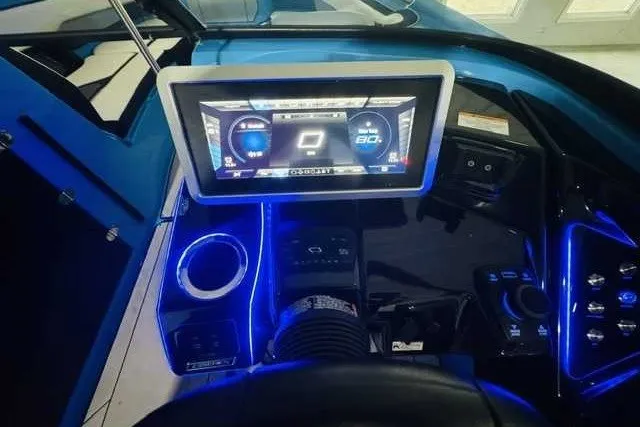 Slide: The Image of Dashboard of 2022 Yamaha Boats 255XD with illuminated controls and digital display. - 9