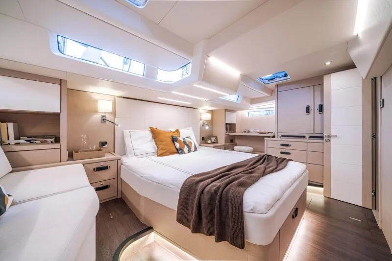 Slide: The Image of Manufacturer Provided Image: Luxurious interior of 2026 Jeanneau 65 yacht with modern design and cozy bedding. - 12