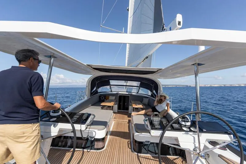 Slide: The Image of Manufacturer Provided Image: 2026 Jeanneau 65 yacht sailing with two people on deck, featuring modern design and open sea views. - 4